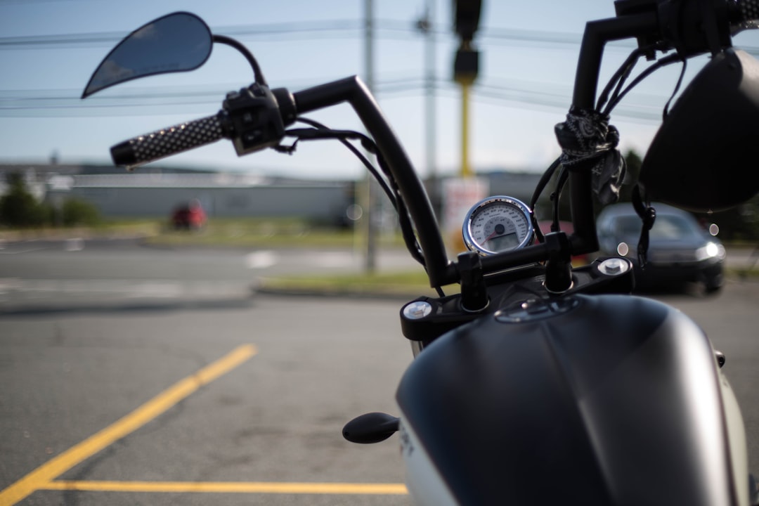 black motorcycle on gray asphalt road during daytime