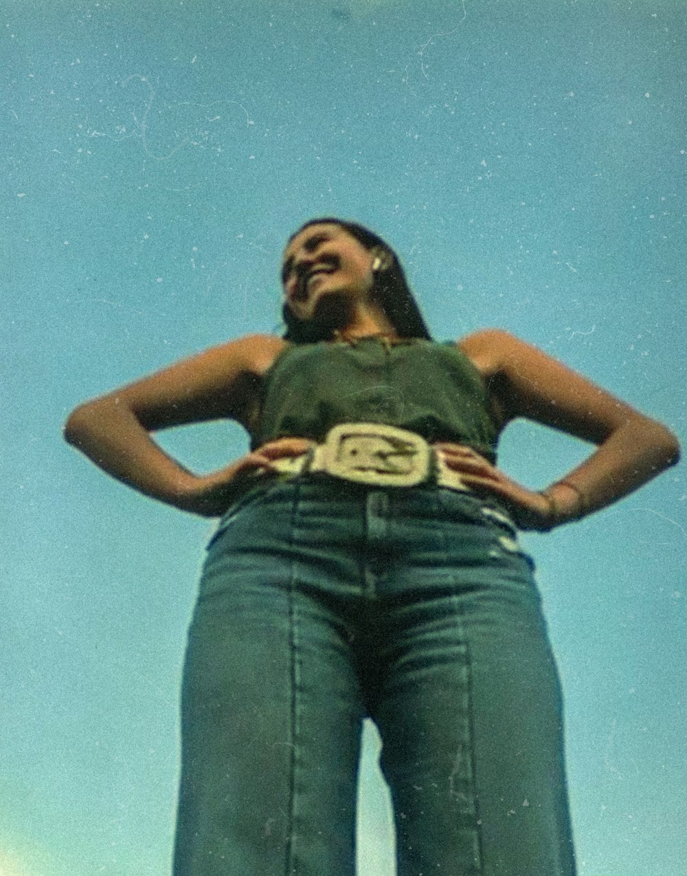 woman in black tank top and blue denim jeans