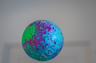 A playful shot of colorful pickleball balls bouncing mid-air during a game.