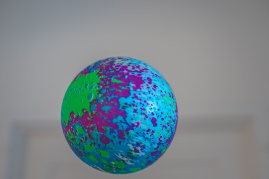 An animated bola ball rolling across a dynamic game board with glowing highlights.