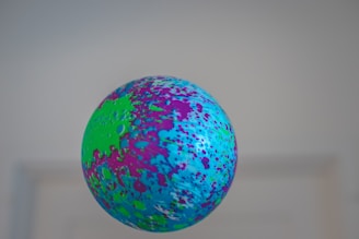 A vibrant, playful game character juggling colorful balls against a bright background.