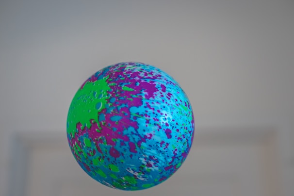 A vibrant, playful game character juggling colorful balls against a bright background.