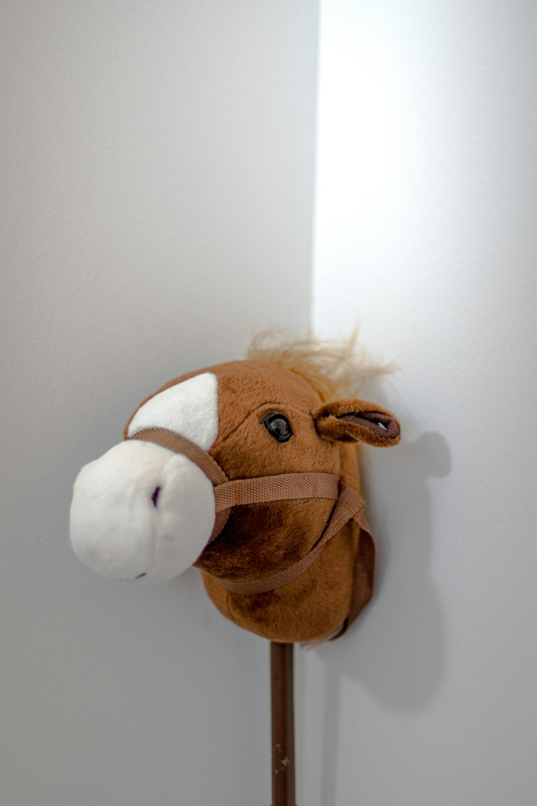 brown and white horse plush toy