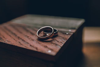 silver ring on brown wooden table