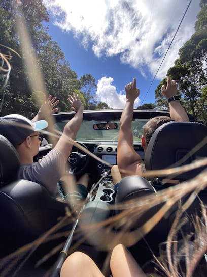 people riding on car during daytime