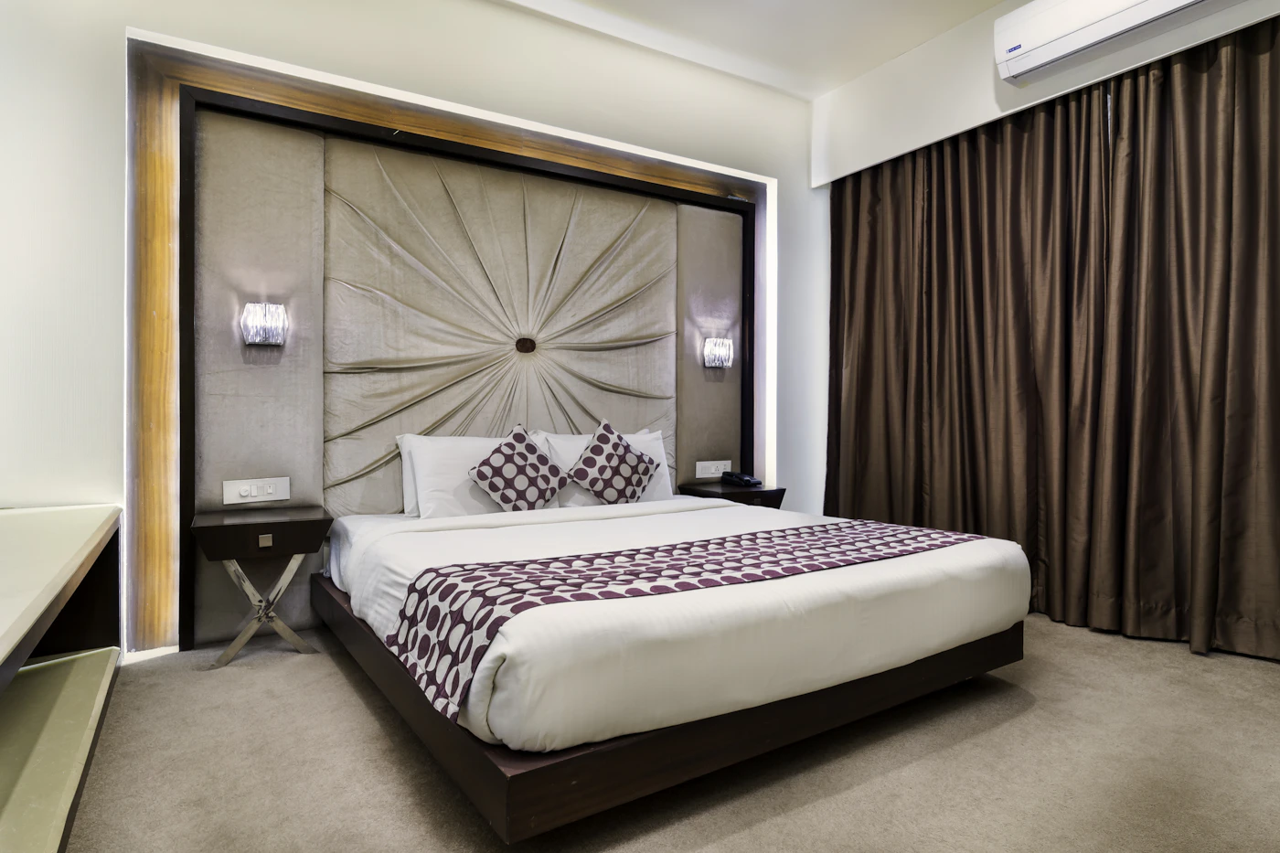 Hotel bedroom with white linens; illustrative accommodation photograph