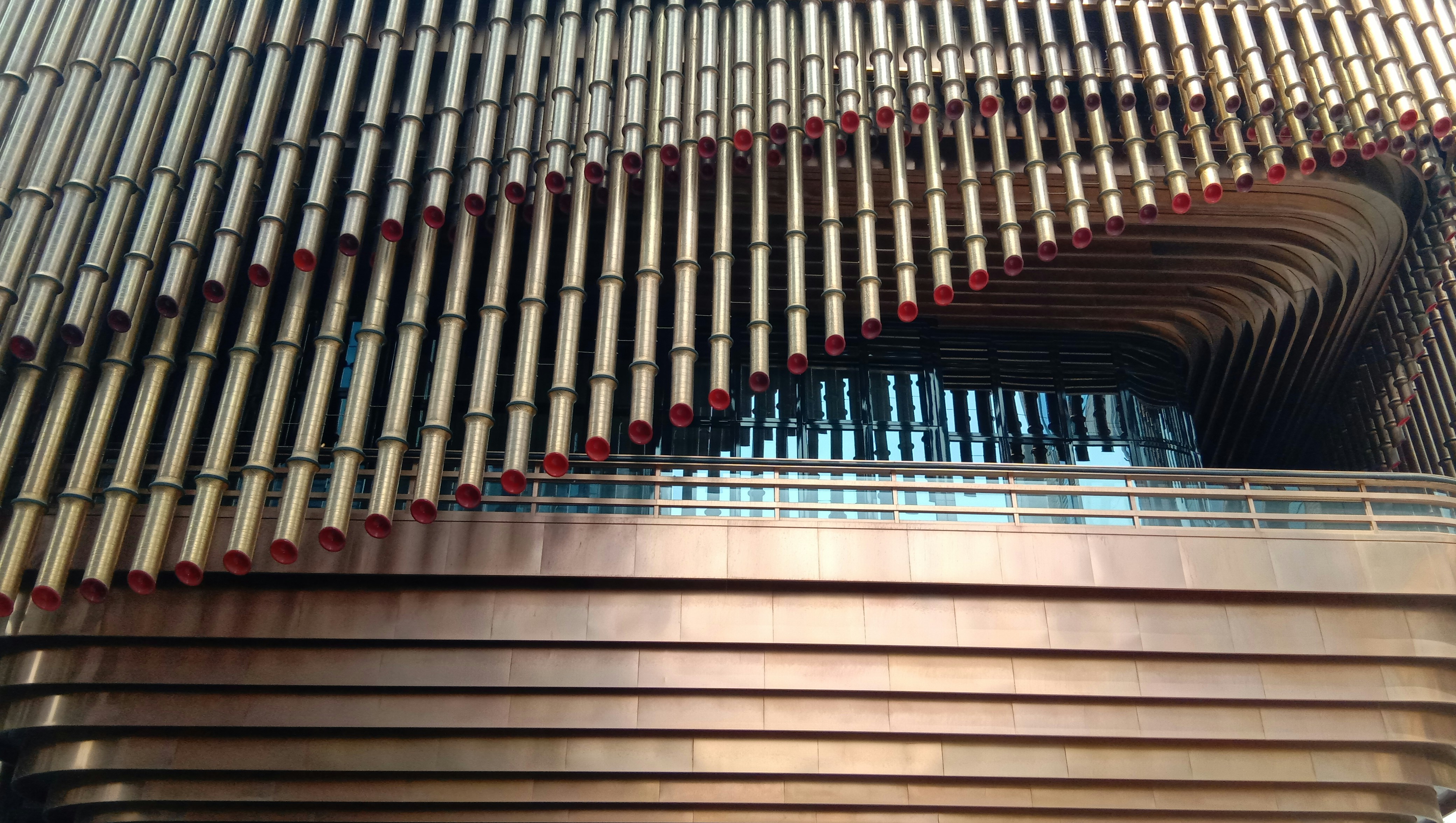 gray concrete building with red and black metal railings