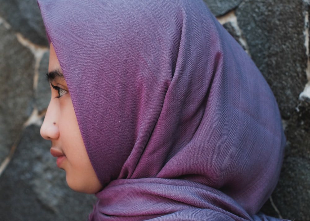 woman in purple hijab and black framed eyeglasses