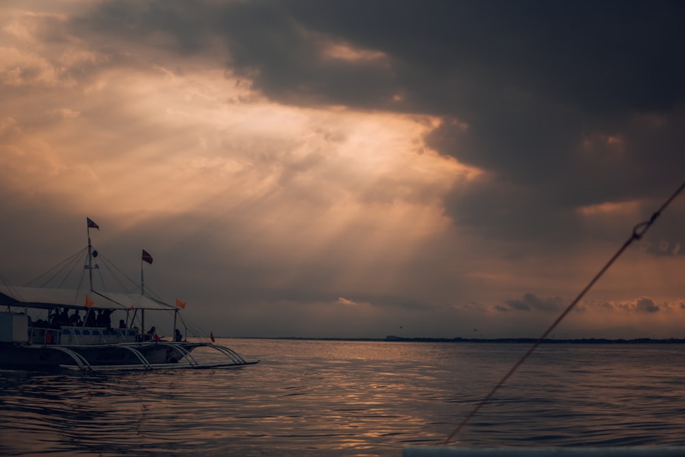 silhouette of person on boat during sunset