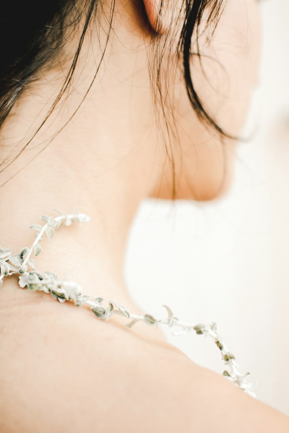 woman wearing white and silver necklace