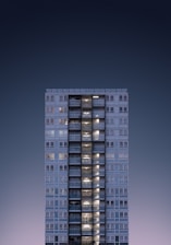 A sleek, minimalistic campus building with sharp angles under a twilight sky.