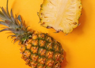 pineapple fruit on yellow surface