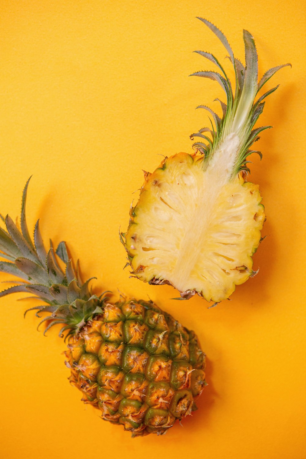 pineapple fruit on yellow surface