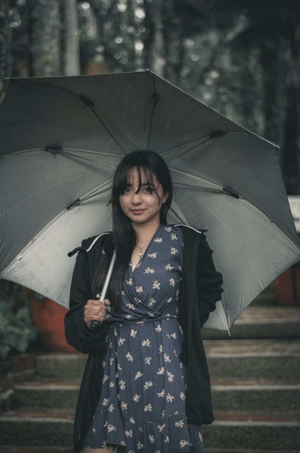 woman in black and white polka dot kimono holding umbrella