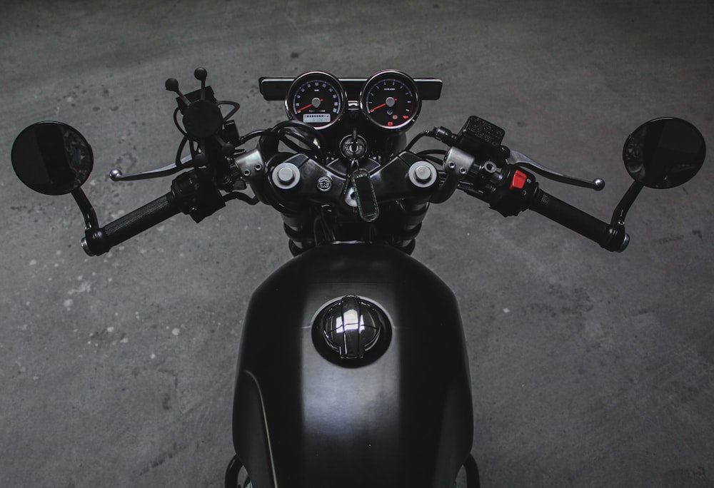 black motorcycle with red and black motorcycle helmet