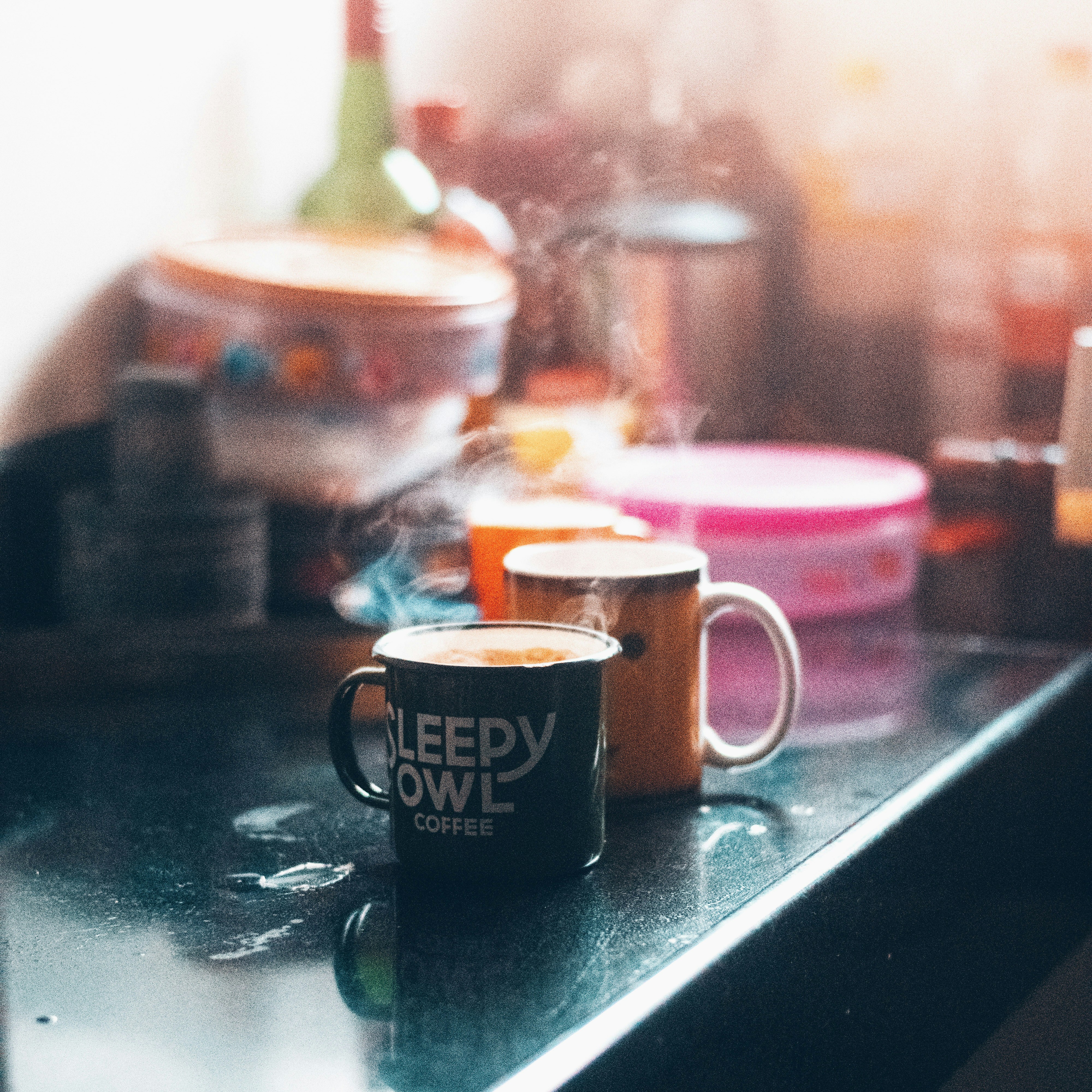 black and yellow ceramic mug on black table