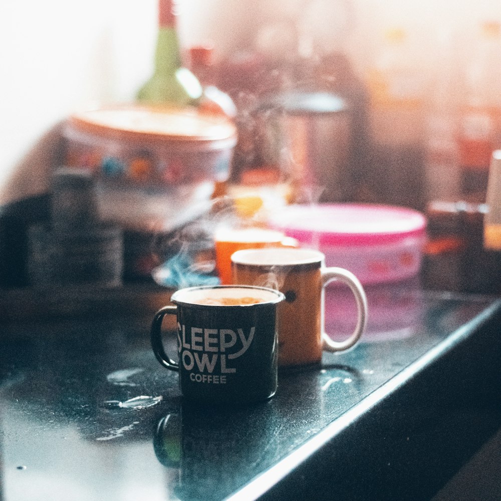 black and yellow ceramic mug on black table