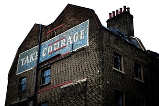 brown brick building with blue and white signage