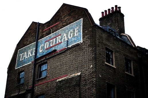 brown brick building with blue and white signage
