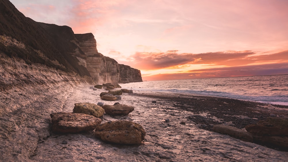 a beach that has some rocks on it