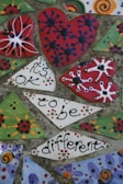 Close-up of a mosaic heart made from colorful broken pottery shards.