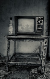 black crt tv on black wooden tv rack