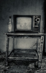 black crt tv on black wooden tv rack