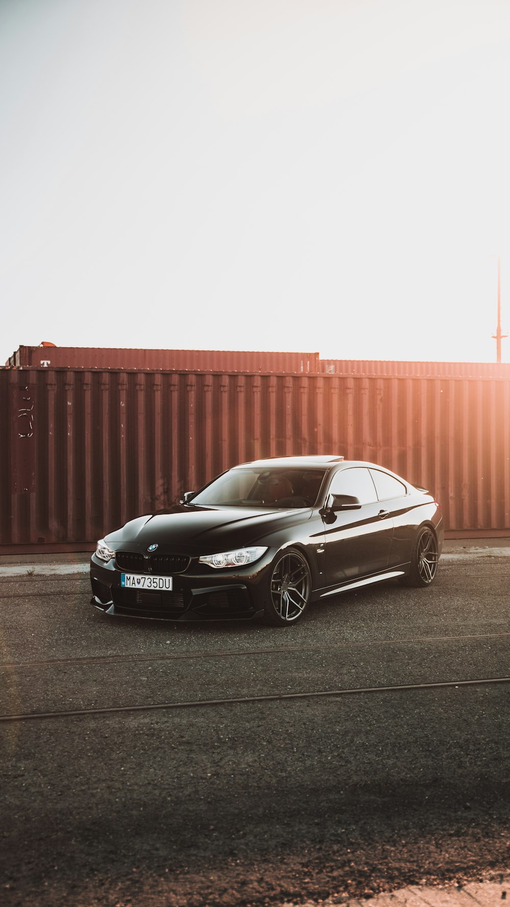 silver mercedes benz coupe parked on gray asphalt road during daytime