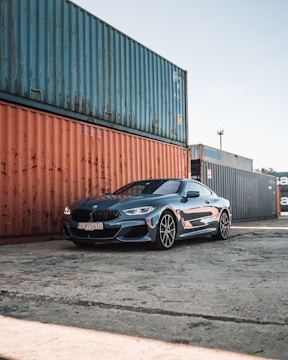 black bmw m 3 coupe parked beside brown wall