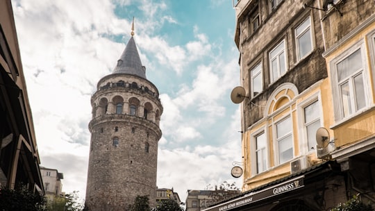 brown concrete building under blue sky during daytime in Galata Tower Turkey