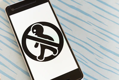 A smartphone displaying a phishing alert notification with a clear warning sign.