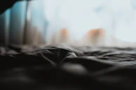 Soft focus image of lingerie fabric with a subtle glow, evoking luxury and comfort.