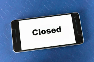 Close-up of a smartphone suddenly shutting down with a low battery warning on screen.