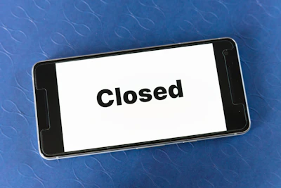 Close-up of a smartphone suddenly shutting down with a low battery warning on screen.