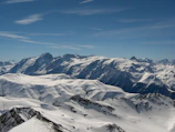 A snowy mountain range in the Swiss Alps under a bright blue sky