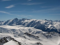 A snowy mountain range with peaks covered in fresh powder.