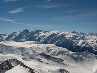A snowy mountain range in the Swiss Alps under a bright blue sky