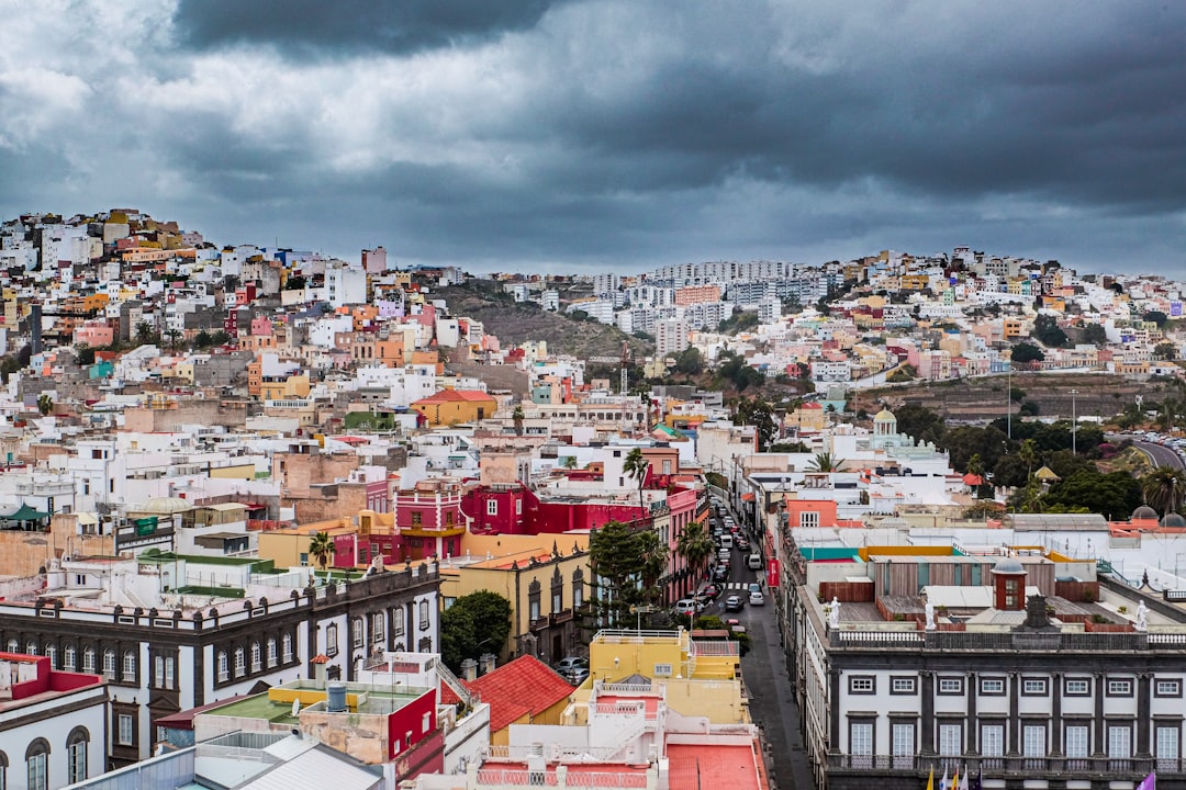 aerial view of city buildings under cloudy sky during daytime