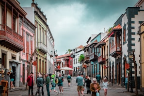 people walking on street between buildings during daytime