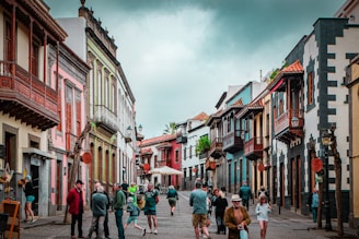 people walking on street between buildings during daytime