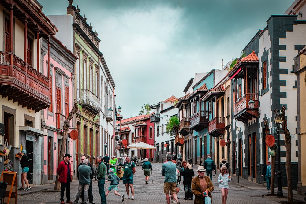 people walking on street between buildings during daytime