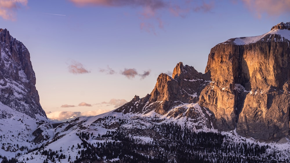 snow covered mountain under cloudy sky during daytime