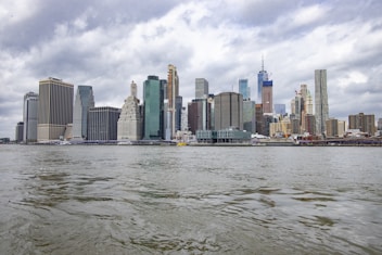 city skyline under cloudy sky during daytime