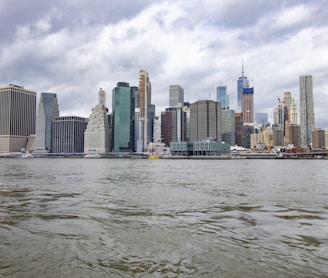 city skyline under cloudy sky during daytime