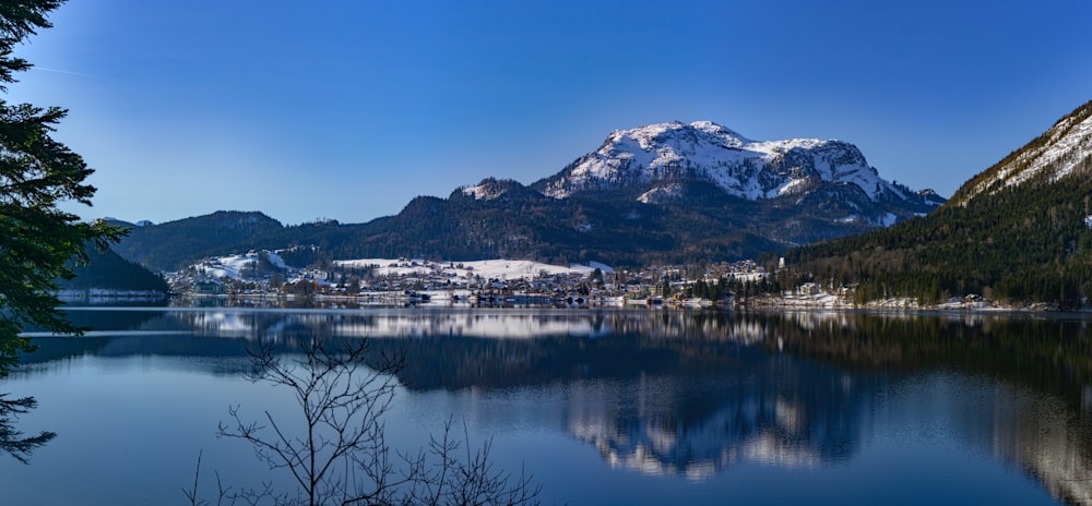 white and black mountain near body of water during daytime