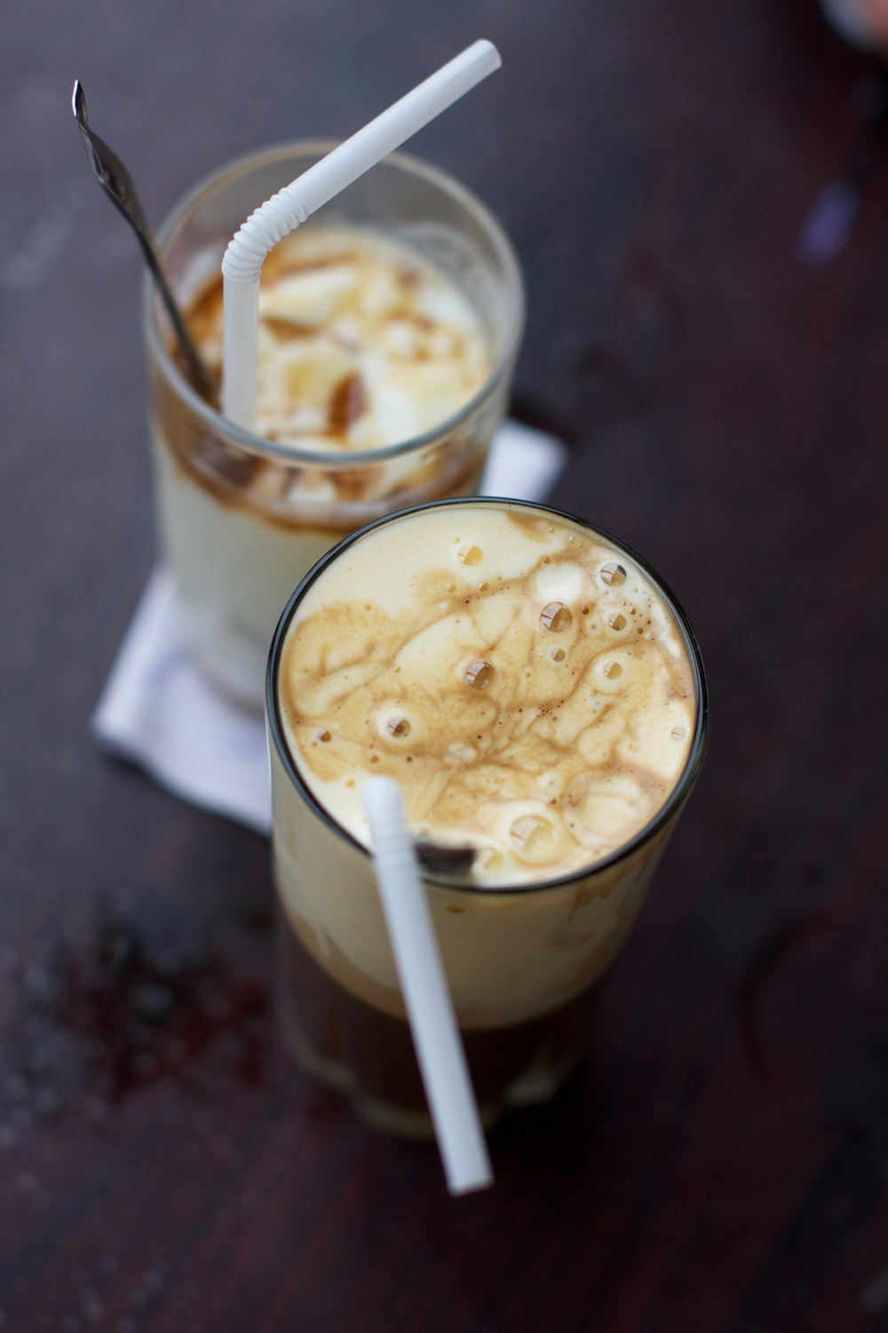 white and brown liquid in clear drinking glass