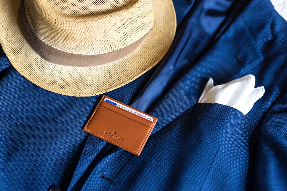 brown fedora hat on blue textile