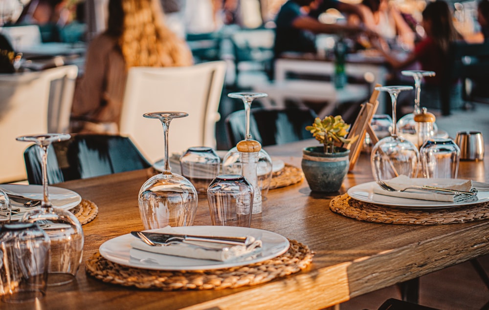 clear glass pitcher and drinking glasses on brown wooden table