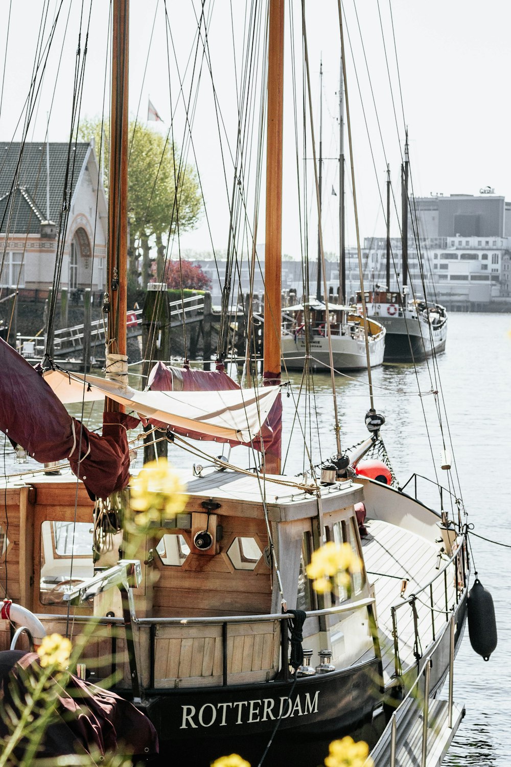 white and brown sail boat on body of water during daytime