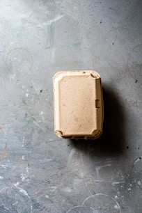 white plastic container on gray concrete floor